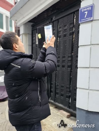 주소정보시설 조사원이 스마트주소점검관리시스템 단말기를 활용해 도로명판을 점검하고 있다.